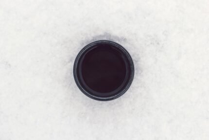 round black container on top of white surface