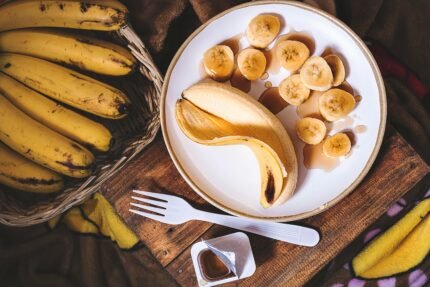 sliced ripe banana on round white ceramic plate